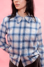 woman wearing a button up shirt made with Japanese soft brushed cotton wool mix in blue and white standing against a pink backdrop.

